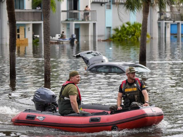 A water rescue boat moves in flood waters at an apartment complex in the aftermath of Hurricane Milton, Thursday, Oct. 10, 2024, in Clearwater, Fla. (AP Photo/Mike Stewart)