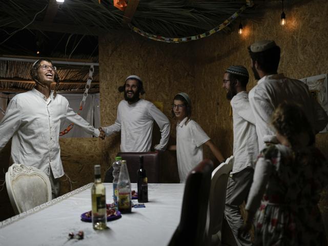 Israelis celebrate the news of the death of Hamas leader Yahya Sinwar, near Kibbutz Erez, southern Israel, on Thursday, Oct. 17, 2024, (AP Photo/Tsafrir Abayov)