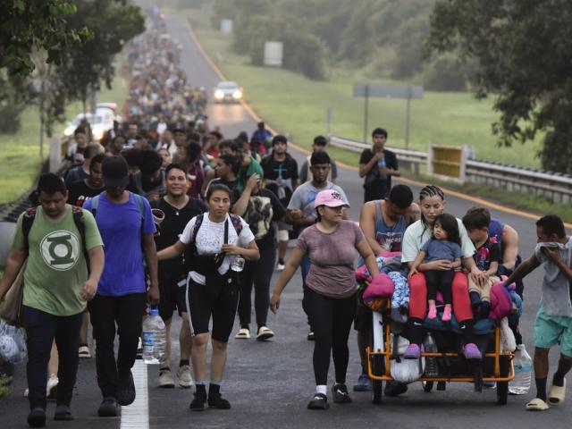 Migrants walk the Huixtla highway in the state of Chiapas, Mexico, Oct. 22, 2024, heading to the United States. (AP Photo/Edgar H. Clemente)