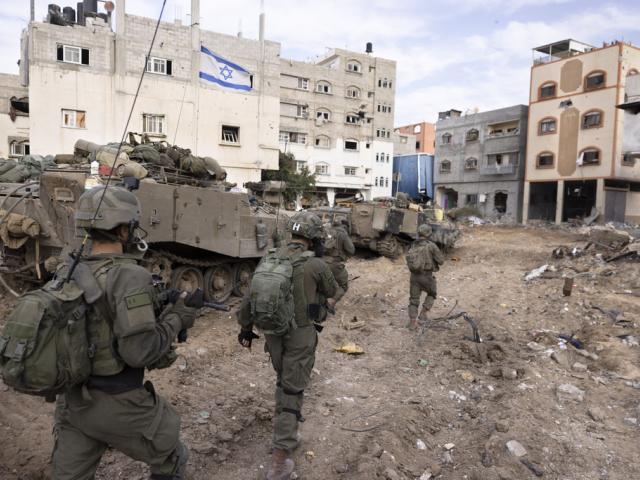 Israeli soldiers walk in Gaza City&#039;s Shijaiyah neighborhood on Dec. 8, 2023. (AP Photo/Moti Milrod, Haaretz, File)