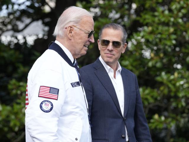 President Joe Biden, wearing a Team USA jacket and walking with his son Hunter Biden, heads toward Marine One on the South Lawn of the White House in Washington, July 26, 2024. (AP Photo/Susan Walsh, File)