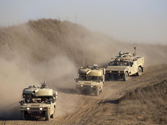 Israeli soldiers drive military vehicles during an exercise in the Israeli-controlled Golan Heights near the border with Syria, Tuesday, Aug. 4, 2020. (AP Photo/Ariel Schalit, File)