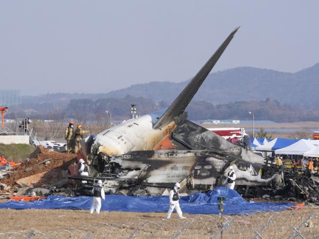 Firefighters and rescue team members work near the wreckage of a passenger plane at Muan International Airport in Muan, South Korea, Sunday, Dec. 29, 2024. (AP Photo/Ahn Young-joon)