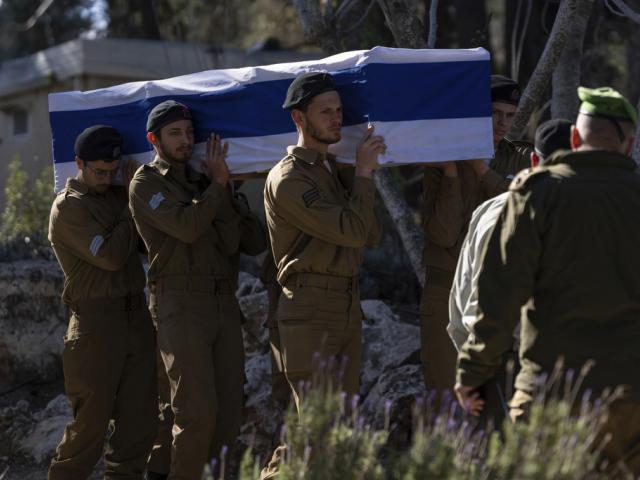 sraeli soldiers and relatives carry the flag-draped casket of 1st Sgt. Matityahu Ya&#039;akov Perel, who was killed in combat in the Gaza Strip, during his funeral at the Mount Herzl cemetery in Jerusalem, Israel, Jan. 9, 2025. (AP Photo/Ohad Zwigenberg)