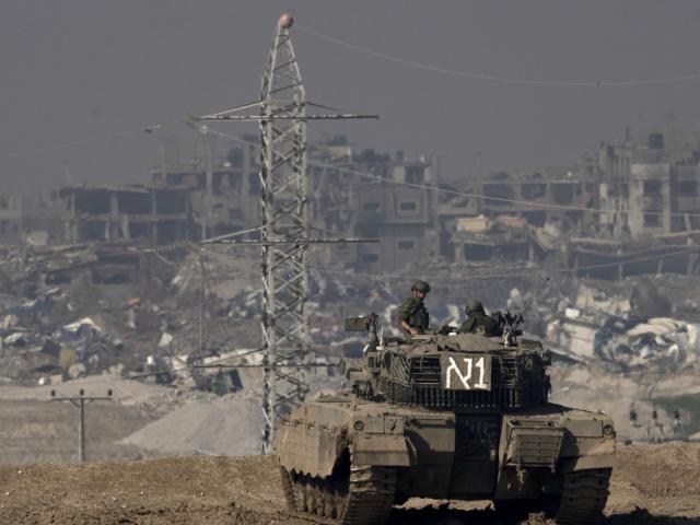  Israeli soldiers overlook the Gaza Strip from a tank, as seen from southern Israel, on Friday, Jan. 19, 2024. (AP Photo/Maya Alleruzzo, File)