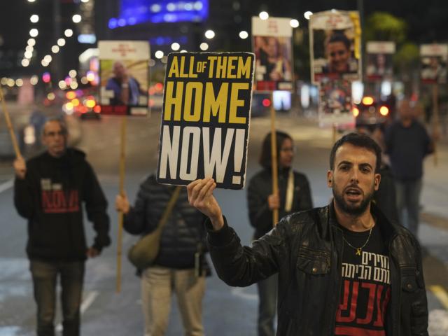 Israeli protesters call for Hamas to release hostages outside the Ministry of Defense headquarters in Tel Aviv, Israel, on Dec. 17, 2024. (AP Photo/Ariel Schalit, File)