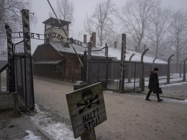 A man walks past the &#039;&#039;Arbeit Macht Frei&quot; (Work Sets You Free) gate at the Memorial and Museum Auschwitz-Birkenau, a former Nazi German concentration and extermination camp, in Oswiecim, Poland, Thursday, Jan. 23. 2025. (AP Photo/Oded Balilty)