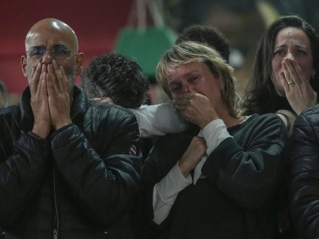 Friends and family of Ohad Ben Ami and Eli Sharabi, who were taken hostage on Oct.7, 2023 attack, watch broadcast of their release from Hamas in Gaza, at the Kibbutz Beeri, Israel, Feb. 8, 2025. (AP Photo/Maya Alleruzzo)