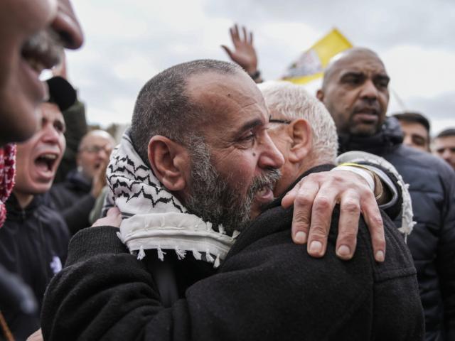 Palestinian prisoners are greeted as they exit a Red Cross bus after being released from Israeli prison following a ceasefire agreement between Israel and Hamas, in the West Bank city of Ramallah, Saturday Feb. 8, 2025. (AP Photo/Mahmoud Illean)