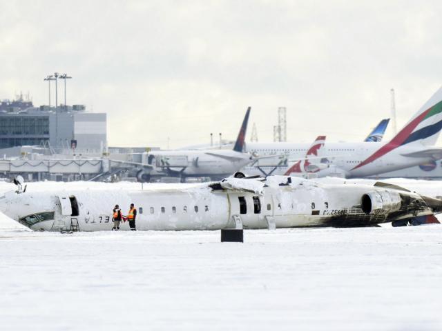 A Delta Air Lines plane lies upside down at Toronto Pearson Airport on Tuesday, Feb. 18, 2025. (Chris Young/The Canadian Press via AP)