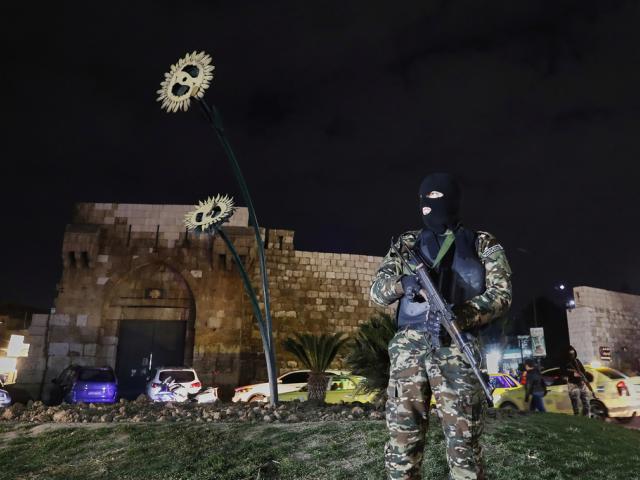 A member of the Syrian government security forces stands guard at a street in Damascus, Syria, Thursday, March 6, 2025. (AP Photo/Omar Sanadiki)