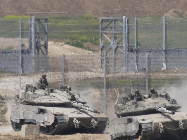 Israeli tank maneuver on the border with northern Gaza Strip as seen from southern Israel, Tuesday, March 18, 2025. (AP Photo/Ohad Zwigenberg)