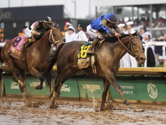 Sovereignty, right, crosses the finish line to win the Kentucky Derby followed by Journalism, at Churchill Downs, May 3, 2025, in Louisville, Ky. (AP Photo/Jeff Roberson)