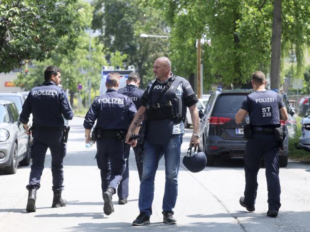 Police officers attend the scene of a shooting at a school in Graz, Austria, Tuesday, June 10, 2025. (Kleine Zeitung via AP)
