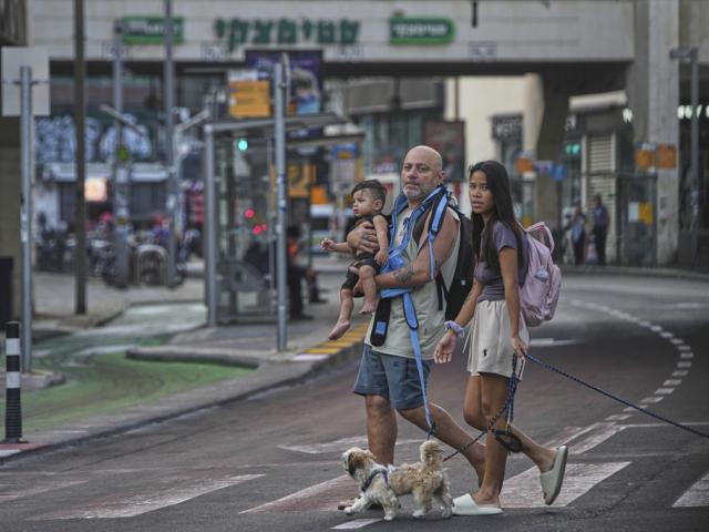 People leave an underground parking garage where they took shelter after an air raid alarm of Iranian missile attacks went off, in Tel Aviv, Israel, Tuesday, June 24, 2025. (AP Photo/Ohad Zwigenberg)