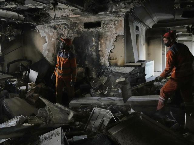 Workers clear rubble of a damaged building, in Tehran, Iran, Wednesday, June 25, 2025, after an Israeli strike on early Tuesday. (AP Photo/Vahid Salemi)