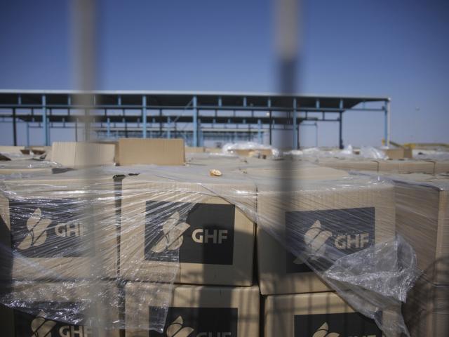 Piles of humanitarian aid packages from GHF , Gaza Humanitarian Foundation, wait to be picked up on the Palestinian side of the Kerem Shalom crossing in the Gaza Strip, Thursday, July 24, 2025. (AP Photo/Ohad Zwigenberg)