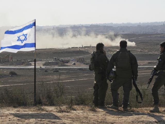 Israeli soldiers watch the northern Gaza Strip from southern Israel, Wednesday, July 30, 2025. (AP Photo/Ohad Zwigenberg)