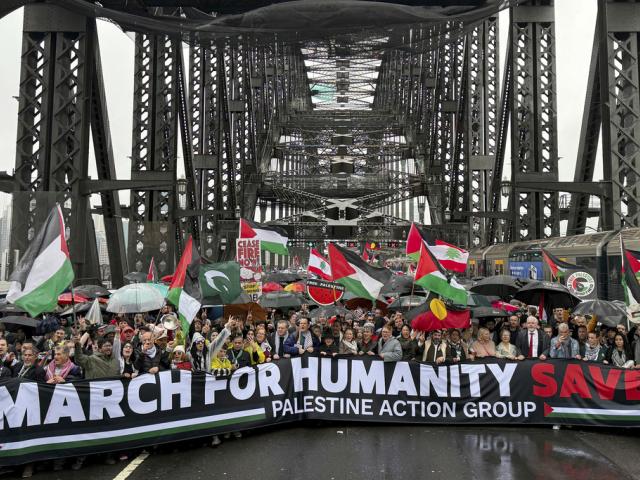 Thousands of protesters walk across the Sydney Harbour Bridge during the Palestine Action Group&#039;s March for Humanity in Sydney, Sunday, August 3, 2025. (Dean Lewins/AAP Image via AP)