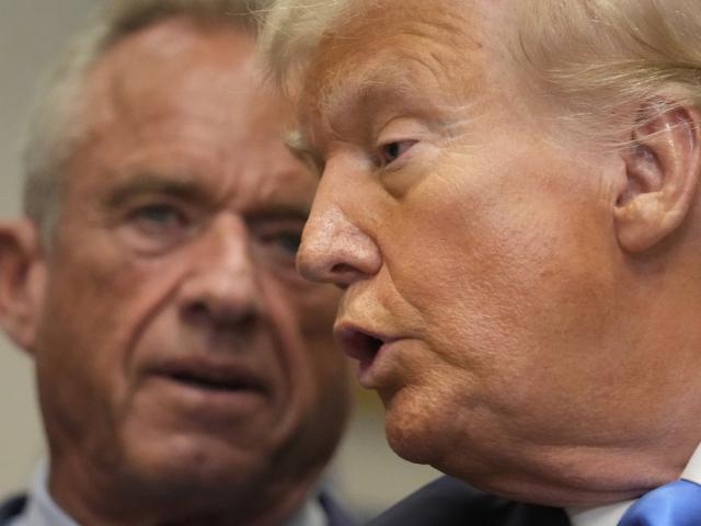 President Trump speaks in the Roosevelt Room of the White House, Sept. 22, 2025, as Health and Human Services Secretary Robert F. Kennedy Jr. listens. (AP Photo/Mark Schiefelbein)