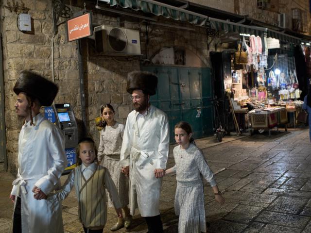Ultra-Orthodox Jewish people make their way to the Western Wall during Rosh Hashanah celebrations, the Jewish New Year, in the Old City of Jerusalem, Tuesday, Sept. 23, 2025. (AP Photo/Leo Correa)