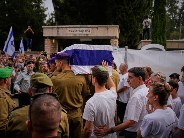 Israeli soldiers carry the flag-draped coffin of Hadar Goldin, a soldier killed in Gaza in 2014 whose body had been held there until its release on Sunday, during the funeral in Kfar Saba, Israel, Tuesday, Nov. 11, 2025. (AP Photo Ohad Zwiegenberg) Israeli soldiers carry the flag-draped coffin of Hadar Goldin, a soldier killed in Gaza in 2014 whose body had been held there until its release on Sunday, during the funeral in Kfar Saba, Israel, Tuesday, Nov. 11, 2025. (AP Photo Ohad Zwiegenberg)