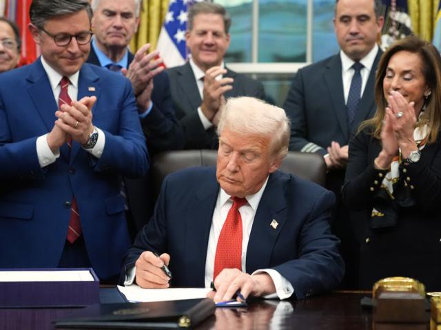 President Donald Trump signs the funding bill to reopen the government, in the Oval Office of the White House, Wednesday, Nov. 12, 2025, in Washington. (AP Photo/Jacquelyn Martin)