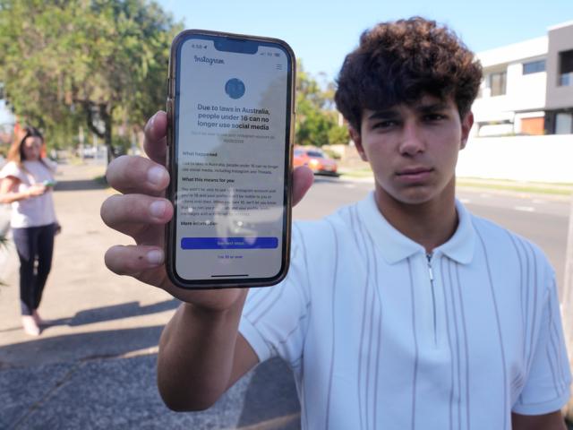 Noah Jones shows a warning on his phone that says he cannot access a social media site as his mother Renee, walks toward him in Sydney, Dec. 9, 2025. (AP Photo/Rick Rycroft) Noah Jones shows a warning on his phone that says he cannot access a social media site as his mother Renee, walks toward him in Sydney, Dec. 9, 2025. (AP Photo/Rick Rycroft)