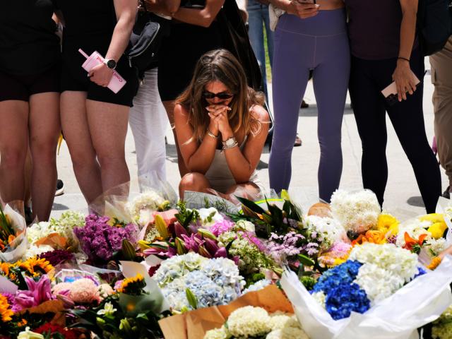 Slide 1 of 17 Previous Next A woman kneels and prays at a flower memorial to shooting victims outside the Bondi Pavilion at Sydney's Bondi Beach, Monday, Dec. 15, 2025, a day after a shooting. (AP Photo/Mark Baker) Slide 1 of 17 Previous Next A woman kneels and prays at a flower memorial to shooting victims outside the Bondi Pavilion at Sydney's Bondi Beach, Monday, Dec. 15, 2025, a day after a shooting. (AP Photo/Mark Baker)