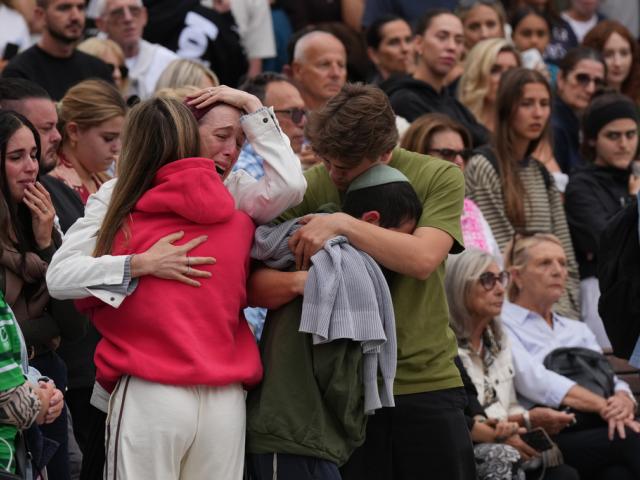 Family members of a victim from Sunday's shooting mourn at a flower memorial made after the shooting at the Bondi Pavilion at Bondi Beach on Tuesday, Dec. 16, 2025, in Sydney, Australia. (AP Photo/Mark Baker) Family members of a victim from Sunday's shooting mourn at a flower memorial made after the shooting at the Bondi Pavilion at Bondi Beach on Tuesday, Dec. 16, 2025, in Sydney, Australia. (AP Photo/Mark Baker)
