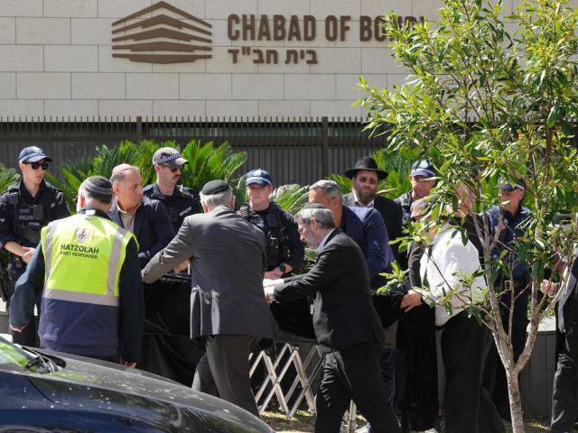A coffin is wheeled into a synagogue in Bondi on Wednesday, Dec. 17, 2025, in Sydney, Australia, before the funeral of Rabbi Eli Schlanger, a victim in the Bondi Beach mass shooting. (AP Photo/Mark Baker) A coffin is wheeled into a synagogue in Bondi on Wednesday, Dec. 17, 2025, in Sydney, Australia, before the funeral of Rabbi Eli Schlanger, a victim in the Bondi Beach mass shooting. (AP Photo/Mark Baker)