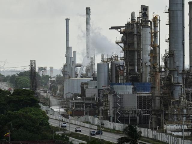 Vehicles drive past the El Palito refinery in Puerto Cabello, Venezuela, Sunday, Dec. 21, 2025. (AP Photo/Matias Delacroix)
