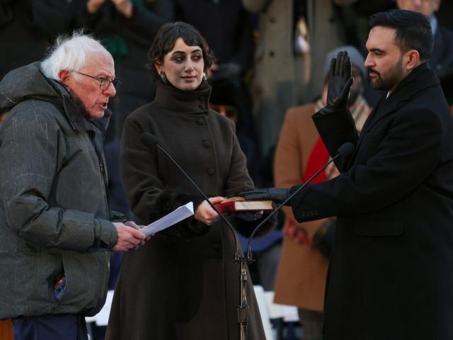 Sen. Bernie Sanders, I-Vt. administers the oath of office to Mayor Zohran Mamdani as Rama Duwaji holds the Quran during Mamdani's inauguration ceremony, Thursday, Jan. 1, 2026, in New York. (AP Photo/Heather Khalifa)