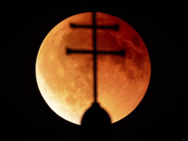 A total lunar eclipse, red (blood) full Moon, over the towers of the Church of St. John of Nepomuk near Telc in the Highlands of the Czech Republic, September 7, 2025. (Photo: Jaroslav Svoboda /CTK via AP Images)