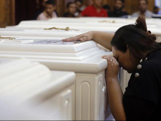 A relative of a slain Christian grieves during funeral service at Church of Great Martyr Prince Tadros, in Minya, Egypt, Saturday, Nov. 3, 2018. AP Photo.