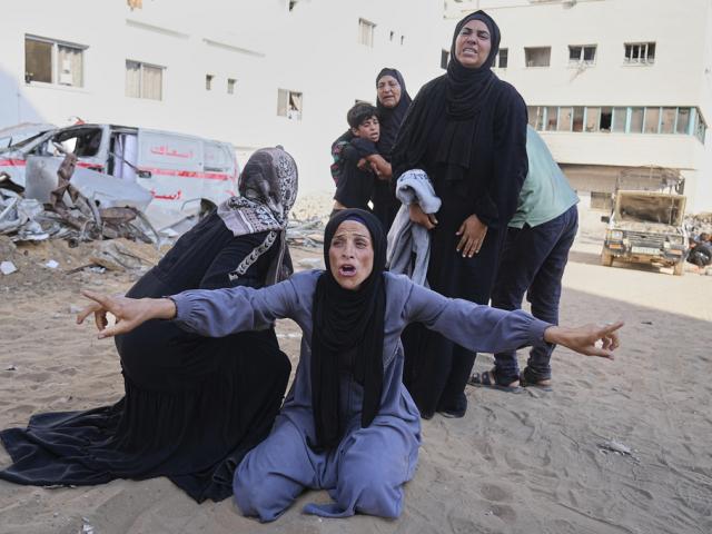 Palestinians mourn relatives who were killed while heading to an aid distribution hub, at Shifa Hospital in Gaza City, June 18, 2025. (AP Photo/Jehad Alshrafi)