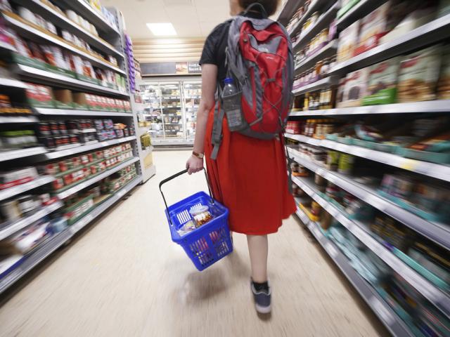 A shopper walks through a supermarket as grocery price inflation continues. (Press Association via AP Images)