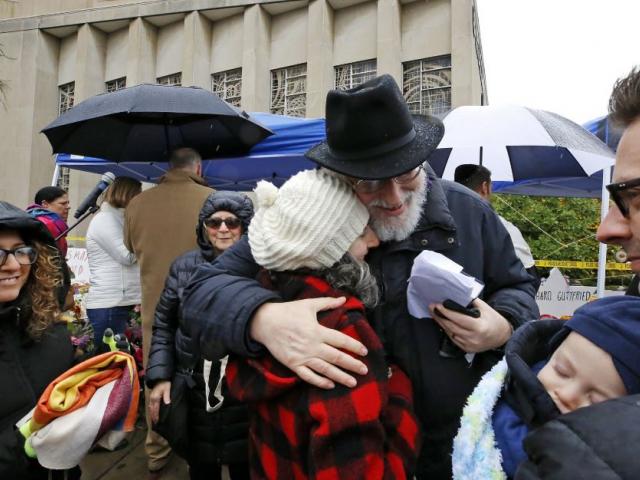 Rabbi Chuck Diamond, center, a former Rabbi at the Tree of Life Synagogue, hugs a woman after leading a Shabbat service outside the Tree of Life Synagogue, Saturday, Nov. 3, 2018 in Pittsburgh. AP Photo. 