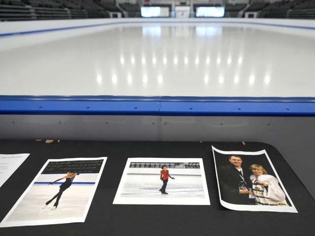 Photographs of aircraft crash victims from The Skating Club of Boston rink displayed rink side, Jan. 30, 2025, in Norwood, Mass. From left is skater Jinna Han, skater Spencer Lane and coaches Vadim Naumov and Evgenia Shishkova. (AP Photo/Charles Krupa)