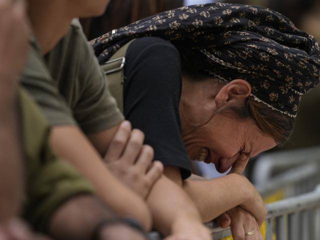 A woman cries during the funeral of Israeli Col. Roi Levy, who was killed by Palestinian terrorists, on Monday, Oct. 9, 2023. (AP Photo/Maya Alleruzzo) A woman cries during the funeral of Israeli Col. Roi Levy, who was killed by Palestinian terrorists, on Monday, Oct. 9, 2023. (AP Photo/Maya Alleruzzo)