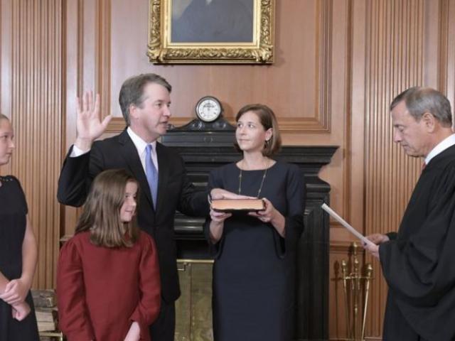Chief Justice John Roberts, right, administers the Constitutional Oath to Judge Brett Kavanaugh in the Justices’ Conference Room of the Supreme Court Building. Ashley Kavanaugh holds the Bible.