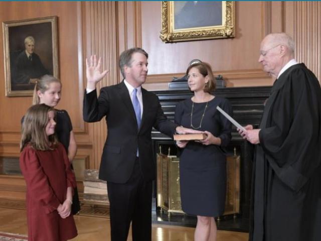 Retired Justice Anthony M. Kennedy, right, administers the Judicial Oath to Judge Brett Kavanaugh in the Justices’ Conference Room of the Supreme Court Building. Ashley Kavanaugh holds the Bible. AP Photo.