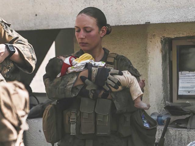 Marine holds infant