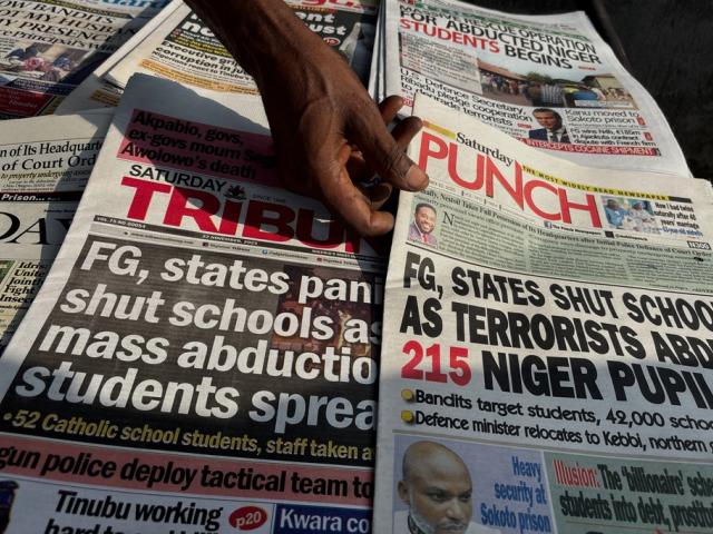 Local newspapers in Lagos with headlines on gunmen abducting schoolchildren and staff of the St. Mary&#039;s Catholic Primary and Secondary School in Papiri community in Nigeria, Saturday, Nov. 22, 2025. (AP Photo/Sunday Alamba )