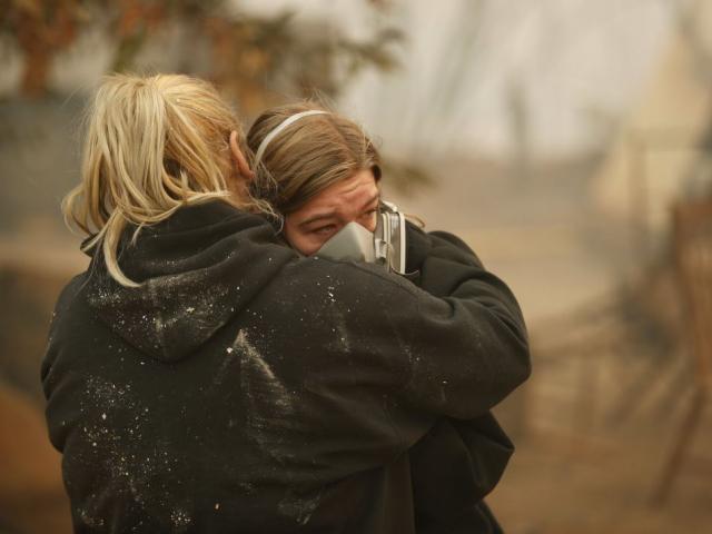 Krystin Harvey, left, comforts her daughter Araya Cipollini at the remains of their home burned in the Camp Fire, Saturday, Nov. 10, 2018, in Paradise, Calif. AP Photo.