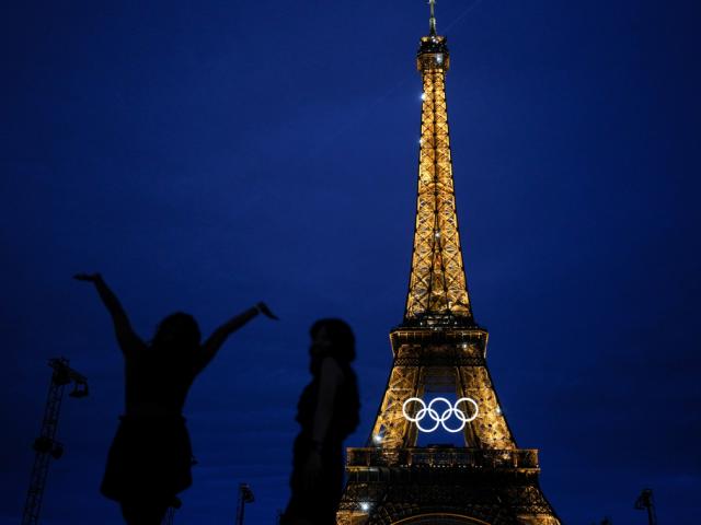 Amarilees Bolorin, left, from the United States, take a selfie with a friend in front of the Eiffel Tower ahead of the 2024 Summer Olympics, Thursday, July 25, 2024, in Paris, France. (AP Photo/Natacha Pisarenko)