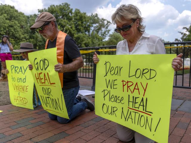 Activists pray for the safety of Biden and Trump at Lafayette Square near the White House, July 14, 2024, one day after an assassination attempt on Trump at a campaign rally in PA. (AP Photo/Mark Schiefelbein)