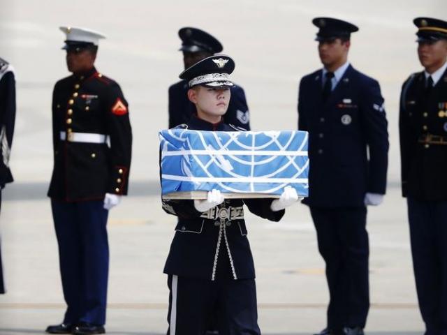 A soldier carries a casket containing the remains of a US service member who was killed in the Korean War during a ceremony at Osan Air Base in Pyeongtaek, South Korea, Friday, July 27, 2018.
