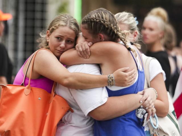 Campers embrace at a reunification area as girls from Camp Waldemar, near the Guadalupe River, are reconnected with their families after flooding in Central Texas, July 5, 2025. (Jason Fochtman/Houston Chronicle via AP)