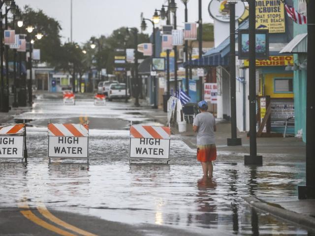 Flood water blocks a section of Dodecanese Blvd at the Tarpon Springs Sponge Docks, Monday morning, Aug 5, 2024, in Tarpon Springs, Fla., as Hurricane Debby passes the Tampa Bay area offshore. (Douglas R. Clifford/Tampa Bay Times via AP)